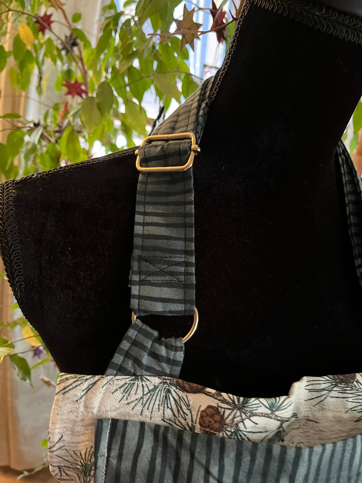 Split-leg Pottery Apron - Pine cones and branches on textured cream with green and black stripe trim0