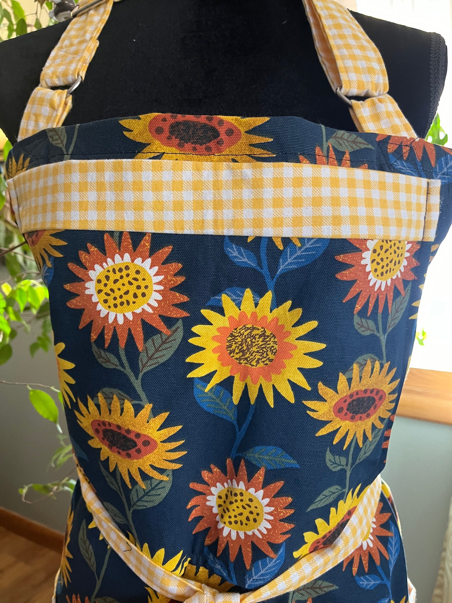 Plus-sized Split leg Pottery Apron - Sunflowers on navy, yellow gingham trim