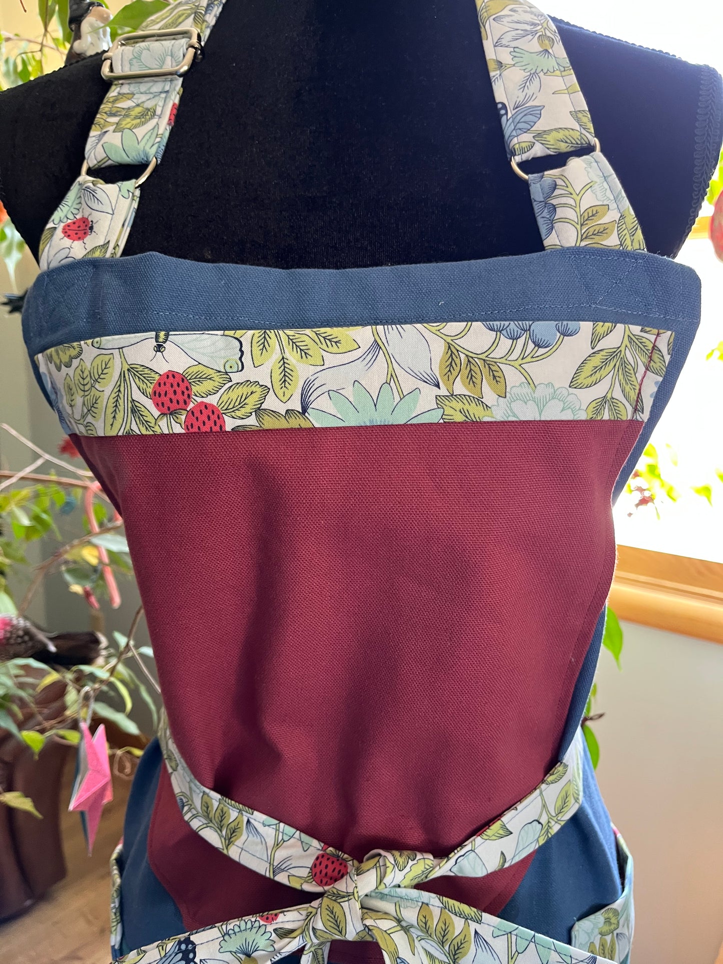 Split-leg Pottery Apron Color block canvas blue/wild plum bib with strawberry floral trim