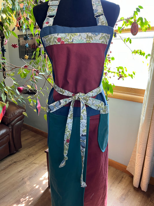 Split-leg Pottery Apron  Color block canvas blue/wild plum bib with strawberry floral trim